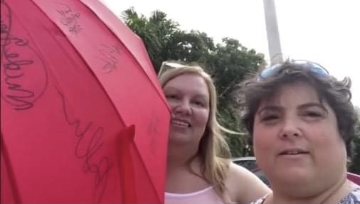 Women veterans signing the umbrella